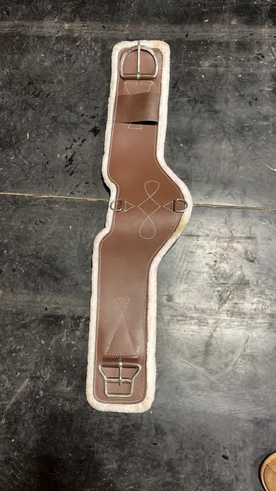 Shaped western cinches with roller buckle