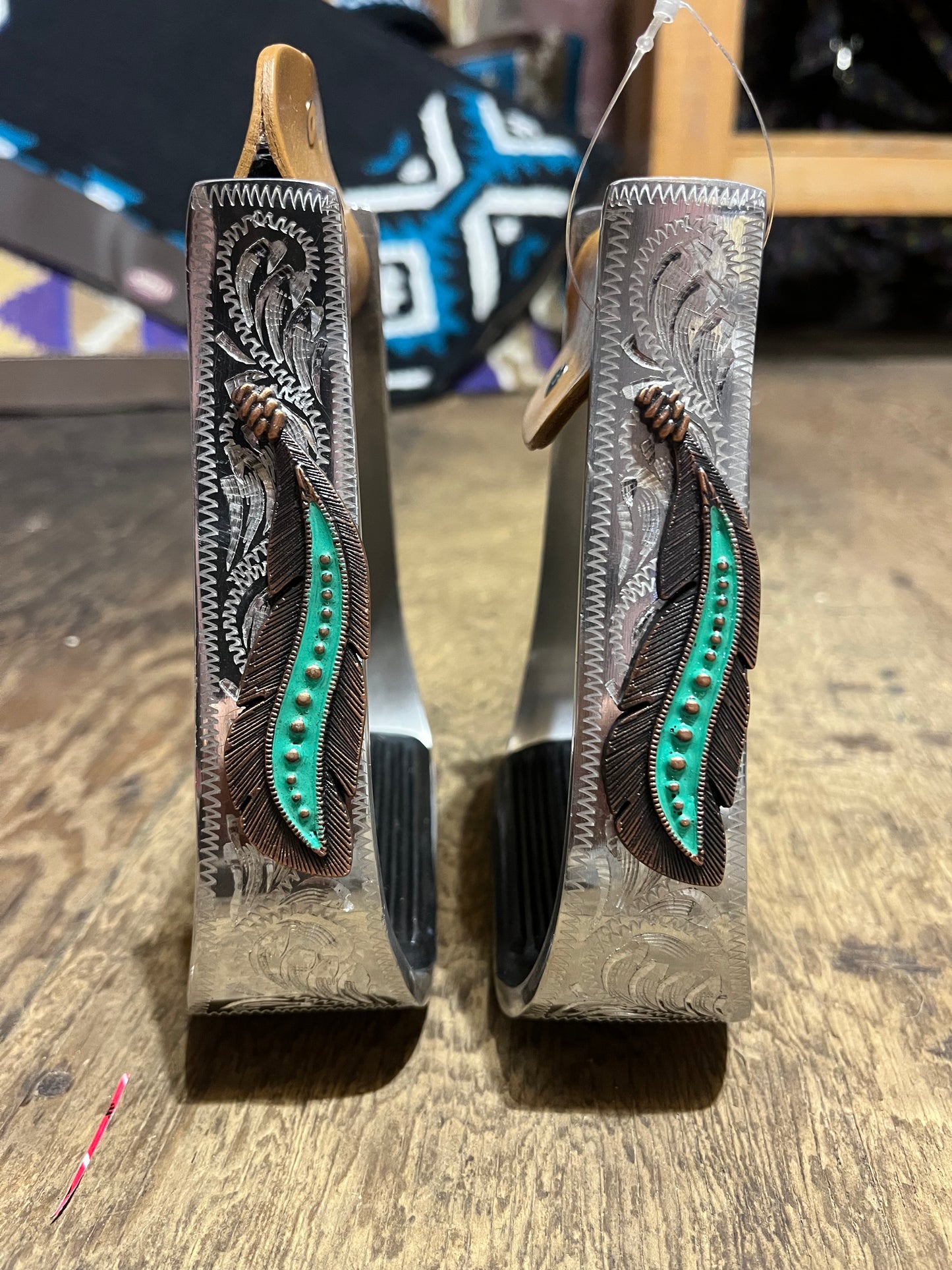 Teal feather engraved barrel stirrups