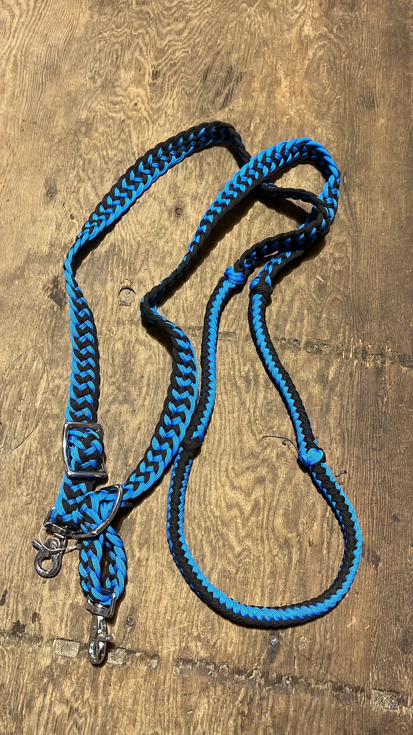 Blue and black adjustable braided barrel reins with snaps