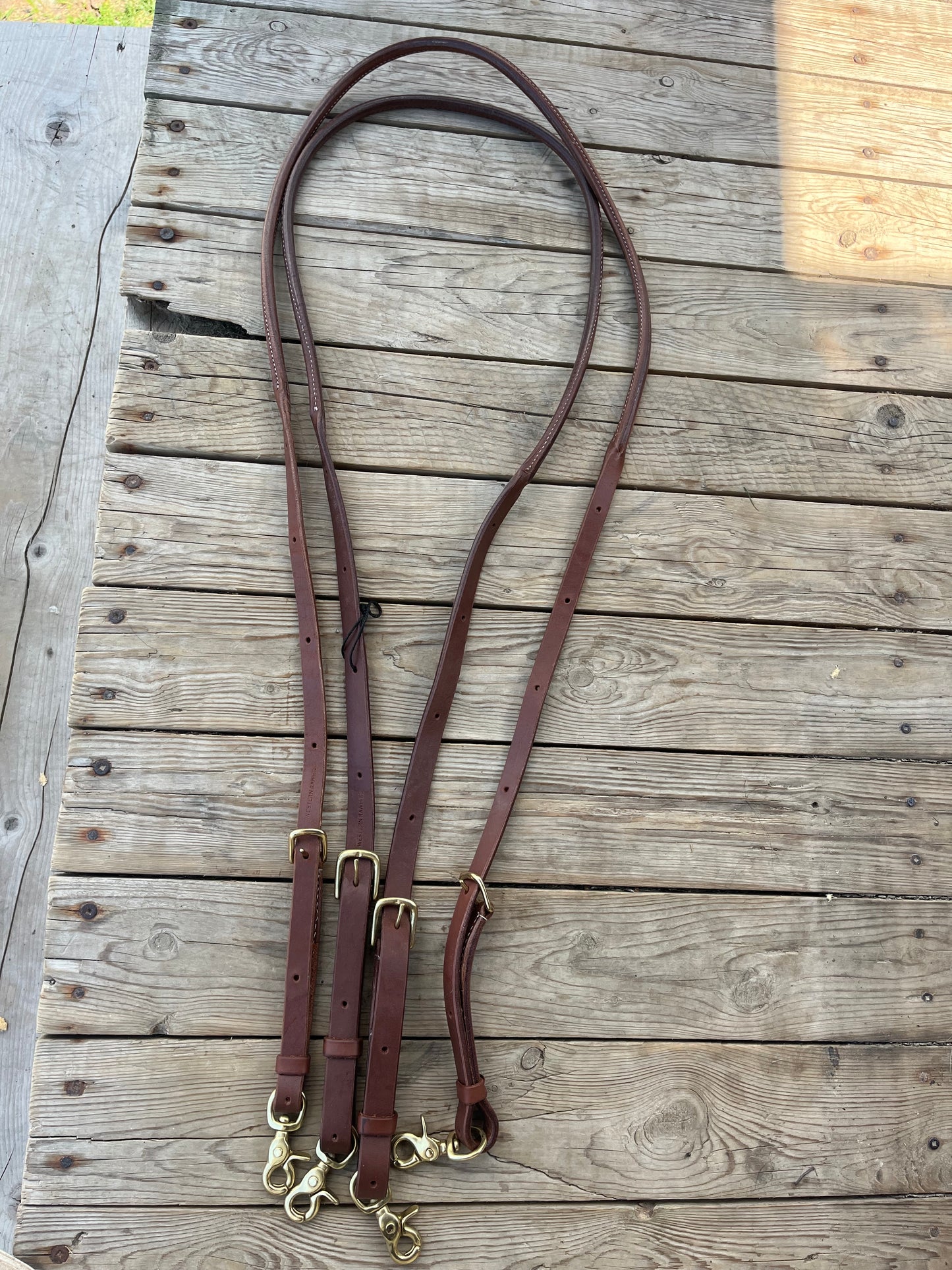 Rolled fully adjustable length supple leather barrel/ roping reins with snaps