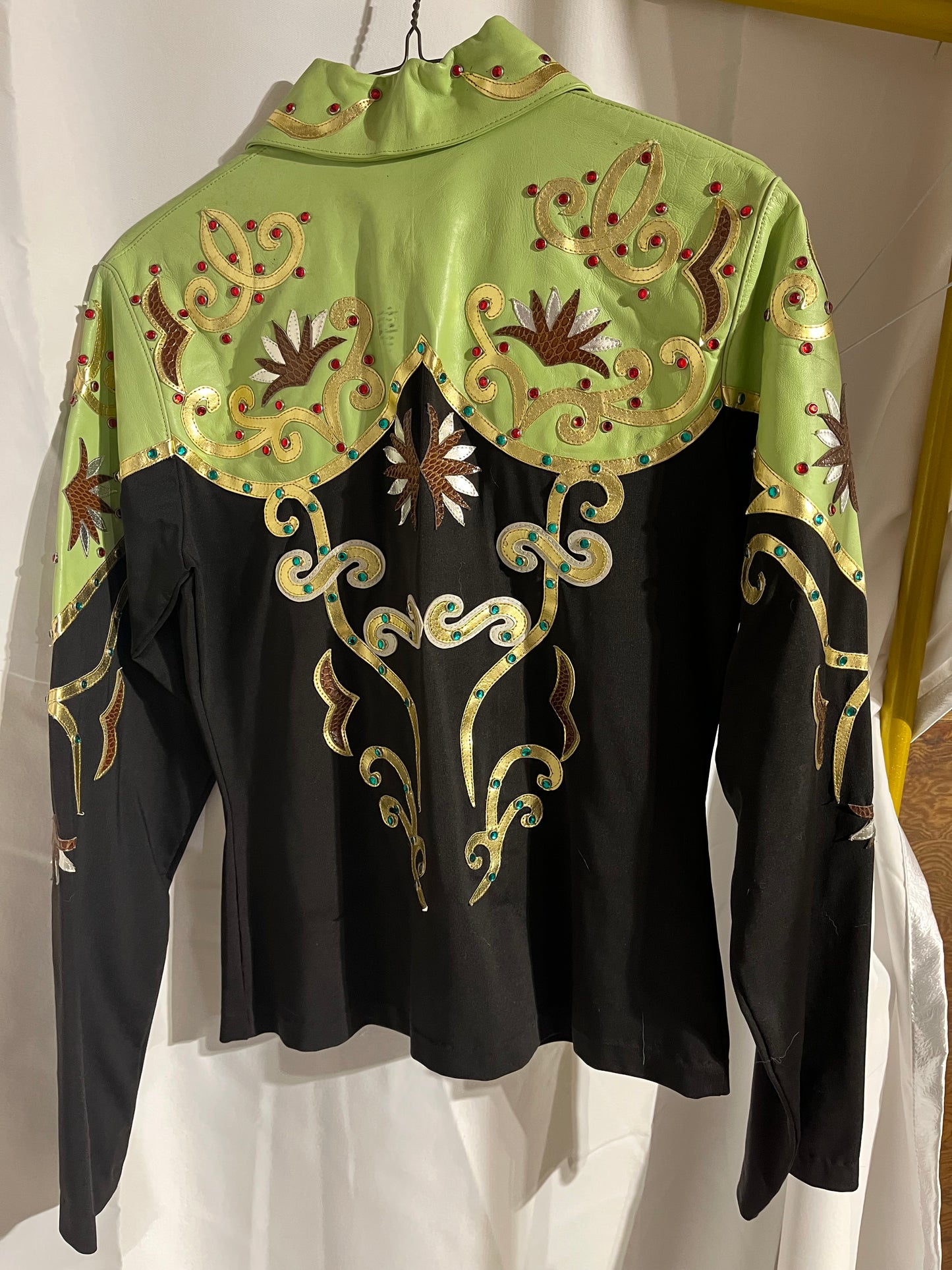 Lime green and black medium show shirt has 2 marks on the back