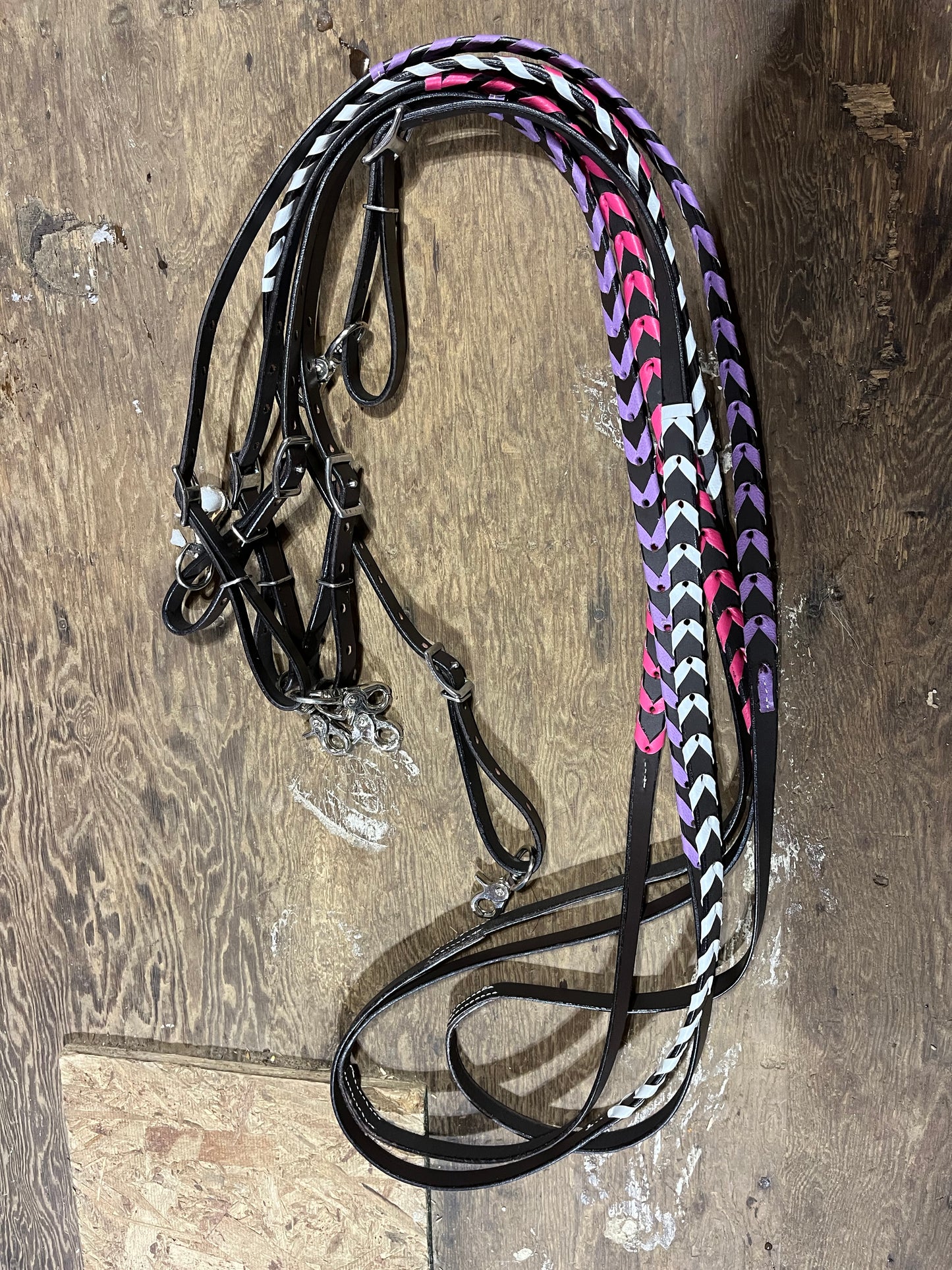 Colorful laced adjustable leather reins, 9ft6 at longest hole with 8 holes per side to adjust
