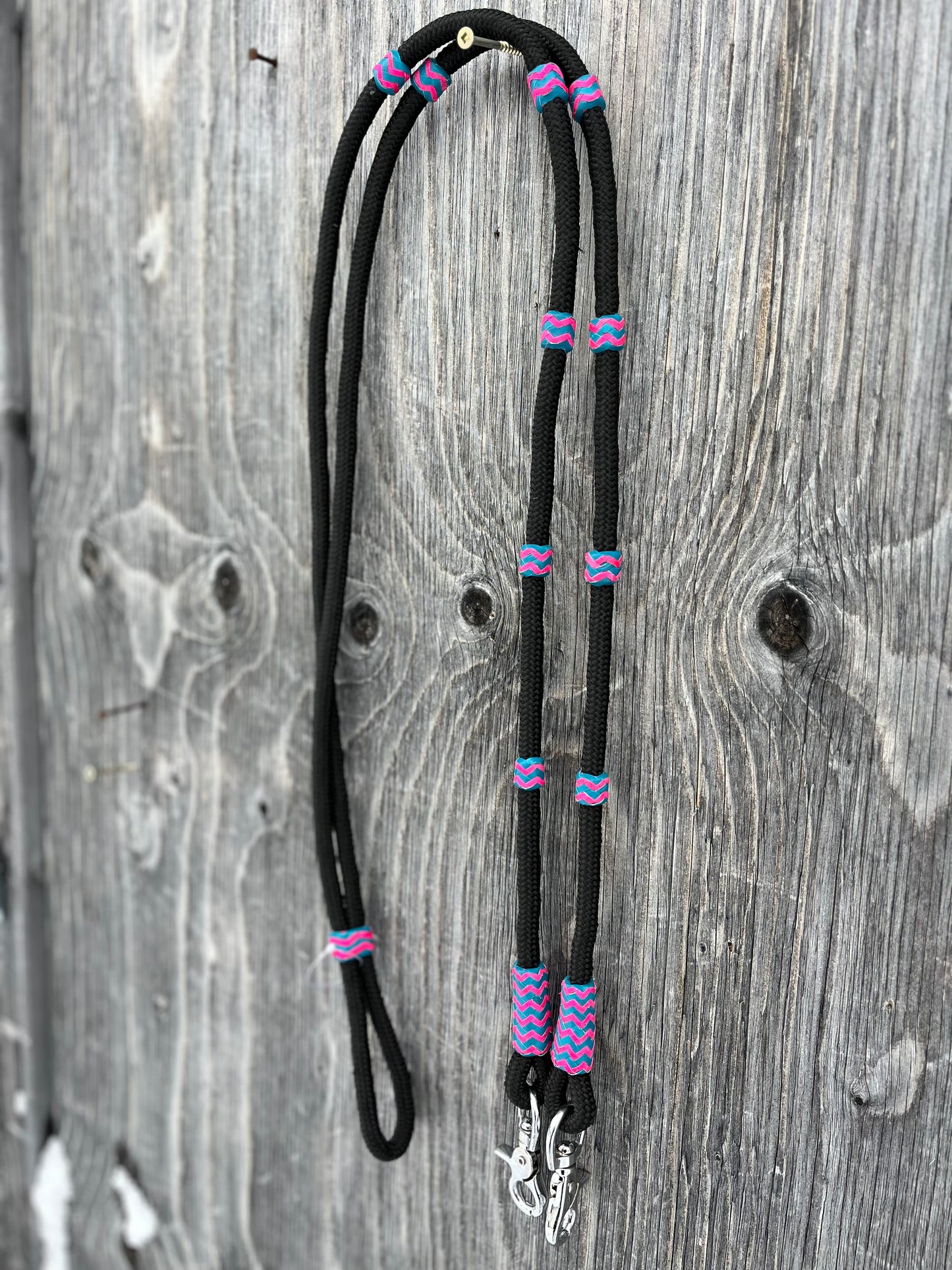 Roping reins with pink and turquoise rawhide accents with snaps