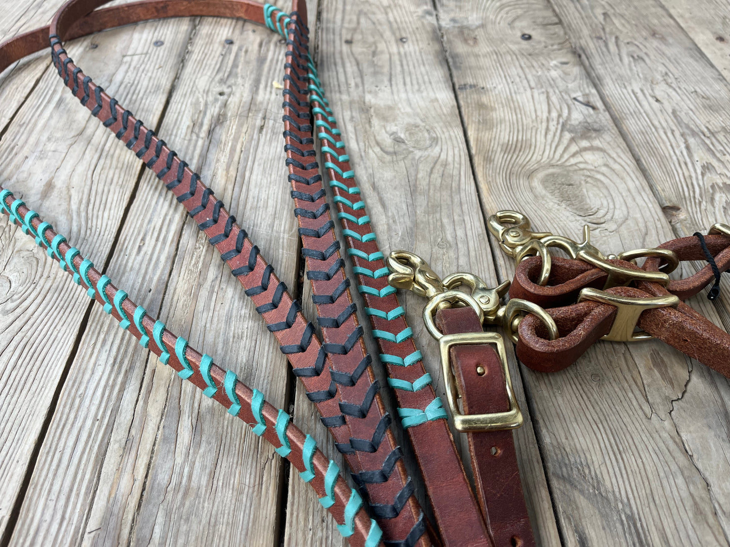 Colored lace harness leather barrel reins with adjustable length and quick change brass hardware snaps