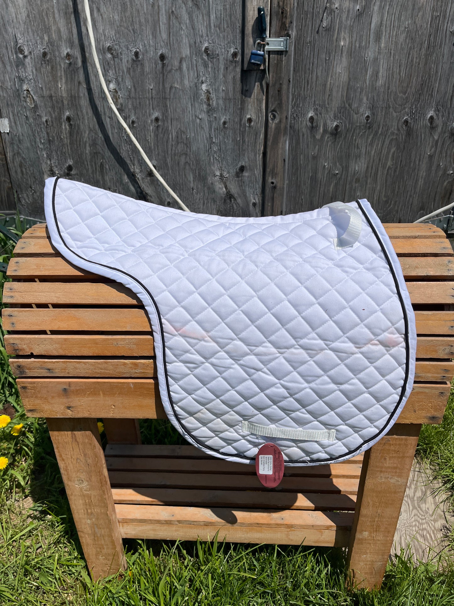 New shaped pad has tags but 2 small pink marks should come out in wash