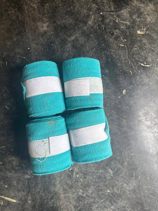 Four teal polos