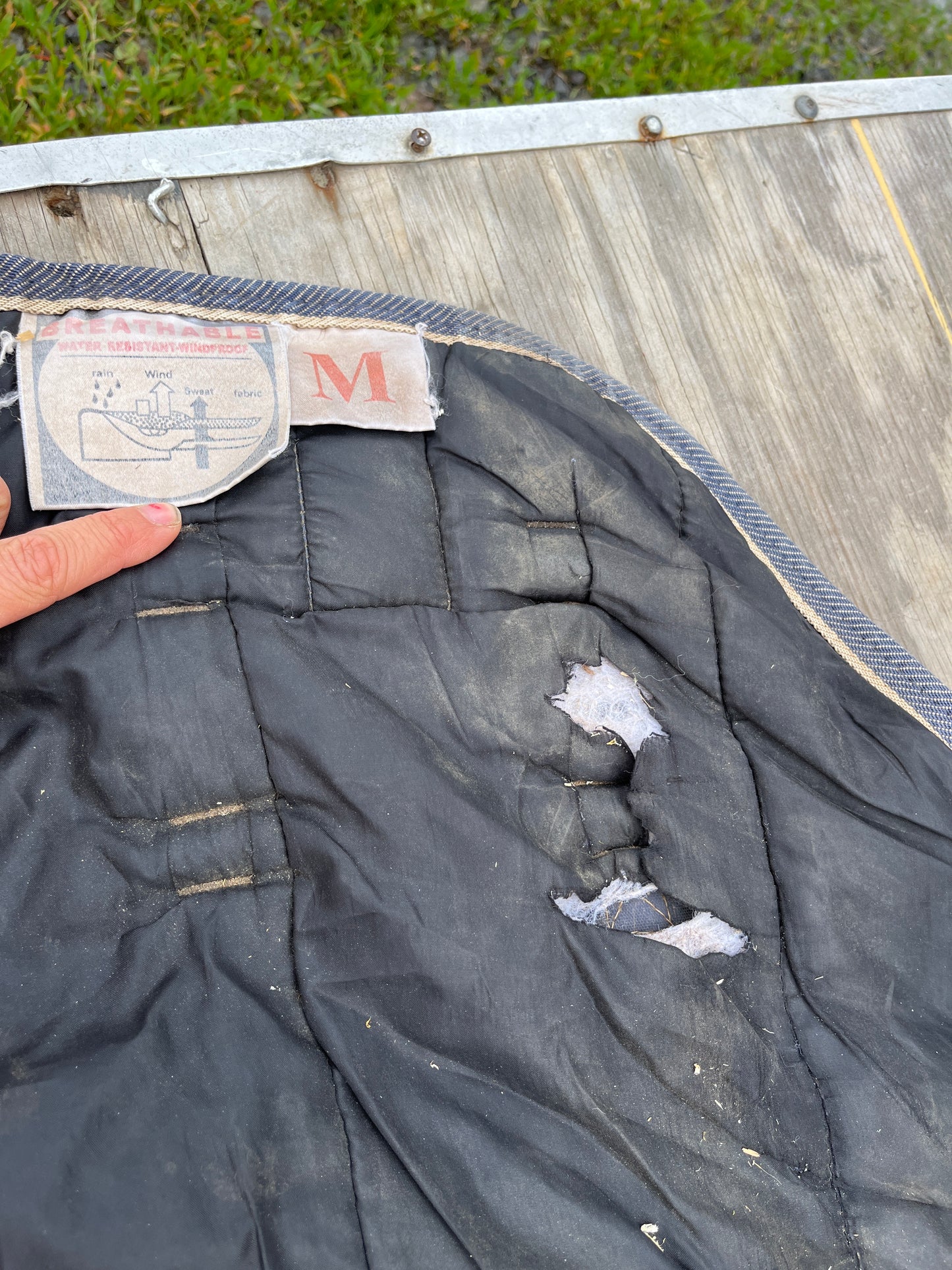 Medium turnout has rips as seen repairable