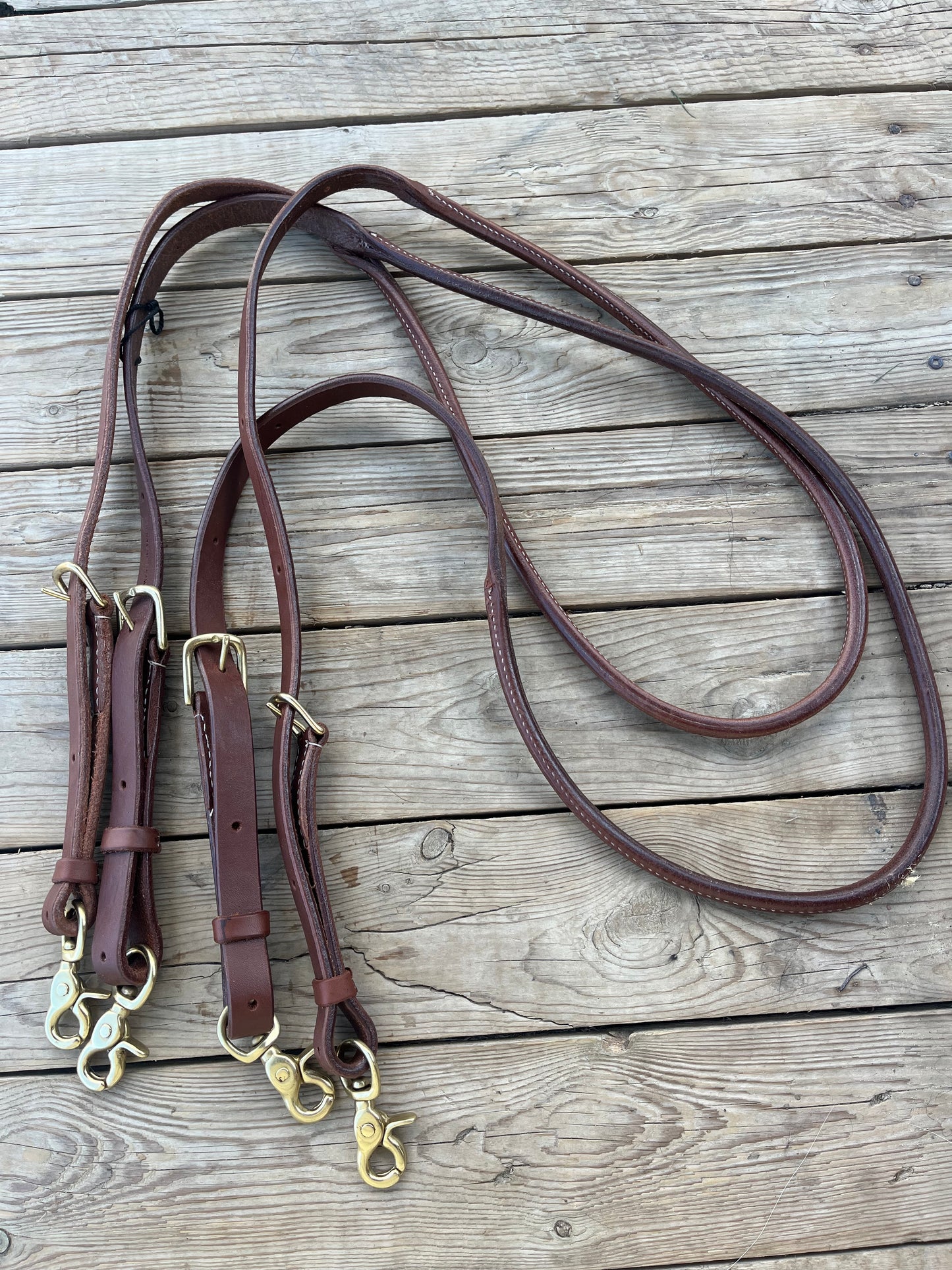 Rolled fully adjustable length supple leather barrel/ roping reins with snaps