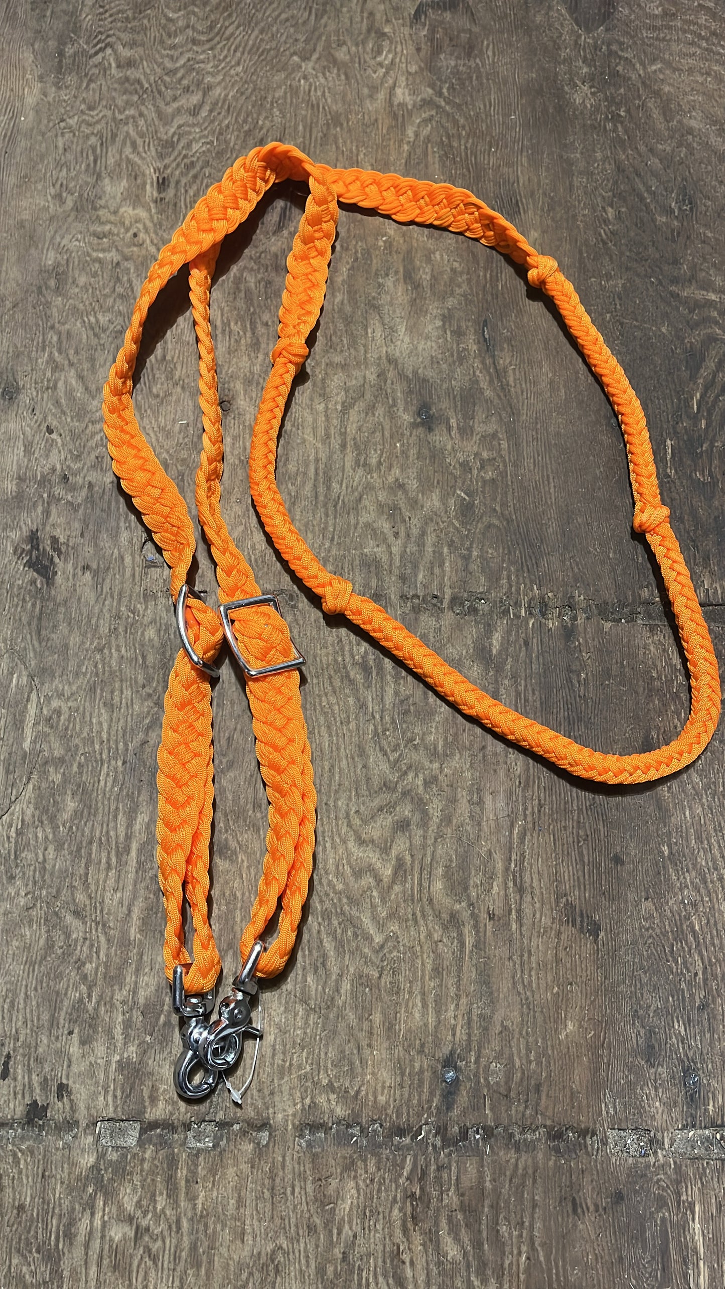 Braided adjustable orange reins with snaps