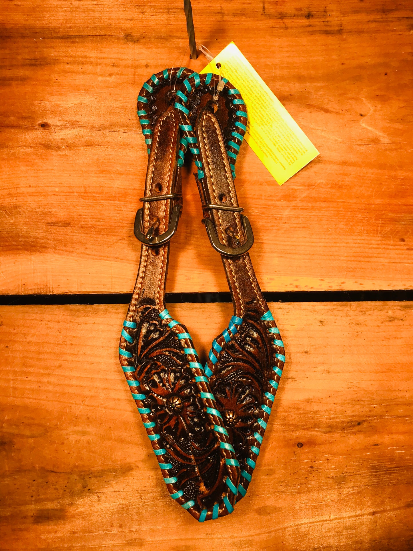 Floral tooled spur straps with buckstitch coloured trim